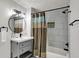 Well-lit bathroom featuring a stylish vanity, modern fixtures, and a shower with elegant gray and white tiling at 1421 Laurel St, Indianapolis, IN 46203