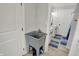 Functional utility sink and a view into the updated bathroom at 1421 Laurel St, Indianapolis, IN 46203