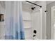 Shower with a shower curtain, modern shower head, and built in shelves at 1421 Laurel St, Indianapolis, IN 46203