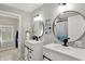 Bright bathroom with dual vanity, modern fixtures, and stylish round mirrors at 1421 Laurel St, Indianapolis, IN 46203