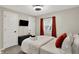 Cozy bedroom with a window, closet, TV, and a comfortable bed at 1421 Laurel St, Indianapolis, IN 46203