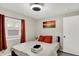 Bedroom featuring warm light, decorative artwork, and a comfortable bed at 1421 Laurel St, Indianapolis, IN 46203