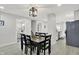 Open-concept dining area with views of the kitchen and staircase boasts a modern light fixture at 1421 Laurel St, Indianapolis, IN 46203