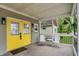Cozy front porch with seating area, stylish railing, and vibrant yellow doors at 1421 Laurel St, Indianapolis, IN 46203