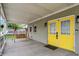 Inviting front porch with a wooden swing and eye-catching yellow front door at 1421 Laurel St, Indianapolis, IN 46203