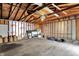 Unfinished garage interior provides ample storage or workshop space with exposed framework at 1421 Laurel St, Indianapolis, IN 46203