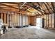 Unfinished garage interior, featuring exposed framework, offers great potential for customization at 1421 Laurel St, Indianapolis, IN 46203