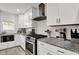 Updated kitchen features stainless steel appliances, granite countertops, and white subway tile at 1421 Laurel St, Indianapolis, IN 46203