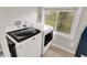 Well-lit laundry room with modern washer and dryer and a window view at 1421 Laurel St, Indianapolis, IN 46203