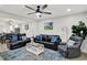 Comfortable living room featuring modern decor, plush leather seating, and a ceiling fan at 1421 Laurel St, Indianapolis, IN 46203