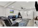 Spacious living room featuring a modern ceiling fan and access to the outdoor porch at 1421 Laurel St, Indianapolis, IN 46203