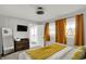 Charming main bedroom features ensuite bath, a TV, and two windows for natural light at 1421 Laurel St, Indianapolis, IN 46203