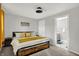 Cozy main bedroom offers soft carpet, a ceiling fan, ensuite bath, and neutral paint at 1421 Laurel St, Indianapolis, IN 46203