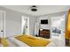 Relaxing main bedroom boasts neutral paint, soft carpet, ensuite bath, and TV at 1421 Laurel St, Indianapolis, IN 46203