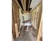 Bathroom under construction with a shower unit surrounded by exposed framing and littered with debris at 1503 E 20Th St, Muncie, IN 47302
