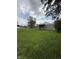Quaint home on a large lot showcasing ample green space for outdoor activities, set against a cloudy sky at 1503 E 20Th St, Muncie, IN 47302
