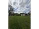 The property features a spacious green lawn and a cozy home with an extension, offering potential for gardening and recreation at 1503 E 20Th St, Muncie, IN 47302