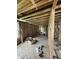 A gutted living room featuring exposed framing, insulation, and subflooring in an unfinished state at 1503 E 20Th St, Muncie, IN 47302