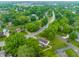 Aerial view of a home in a lush, tree-filled neighborhood with a nearby lake at 15203 Shoreway Ct, Carmel, IN 46032