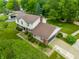 Aerial view of a two-story home with a well-manicured lawn and an attached garage at 15203 Shoreway Ct, Carmel, IN 46032