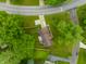 Overhead view of a home with lush green lawn surrounded by mature trees at 15203 Shoreway Ct, Carmel, IN 46032