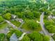 Aerial view of a home with a large lawn and mature trees in a residential neighborhood at 15203 Shoreway Ct, Carmel, IN 46032