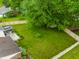 Aerial view of a green backyard featuring a large lawn, wooden fence, trees, and a gazebo with outdoor seating at 15203 Shoreway Ct, Carmel, IN 46032