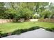 Well-maintained backyard with green lawn, wooden fence, storage shed, and lush trees, creating a serene outdoor space at 15203 Shoreway Ct, Carmel, IN 46032