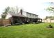 Large backyard showcasing a well-kept lawn, patio area, wooden fence, and tasteful landscaping details at 15203 Shoreway Ct, Carmel, IN 46032