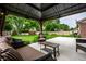 Covered patio featuring stylish seating, a garden, and a view of the well-maintained backyard at 15203 Shoreway Ct, Carmel, IN 46032