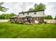 Manicured backyard with a large green lawn and a cozy gazebo for outdoor relaxation at 15203 Shoreway Ct, Carmel, IN 46032