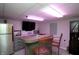 Finished basement bar area featuring stainless fridge, bar seating, granite countertop, and tv at 15203 Shoreway Ct, Carmel, IN 46032