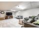 Open basement featuring a cozy living room with gray sofas and modern decor at 15203 Shoreway Ct, Carmel, IN 46032