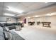 Large basement area with multiple seating areas and recreational features at 15203 Shoreway Ct, Carmel, IN 46032