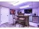 Cozy basement bar area with stools, mini-fridge, and decor at 15203 Shoreway Ct, Carmel, IN 46032