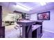 Finished basement bar with barstool seating and access to stairs at 15203 Shoreway Ct, Carmel, IN 46032