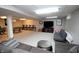 Finished basement featuring a gray sofa, a TV and foosball table, for relaxing at 15203 Shoreway Ct, Carmel, IN 46032