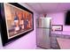 Basement wet bar featuring a stainless steel refrigerator and painting of wine at 15203 Shoreway Ct, Carmel, IN 46032