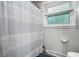 This bathroom has a blue and white patterned shower curtain, window and toilet paper holder at 15203 Shoreway Ct, Carmel, IN 46032