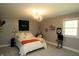 Bright bedroom with carpet, light grey walls, illuminated décor, and a stylish hanging chair at 15203 Shoreway Ct, Carmel, IN 46032