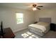 Bedroom with ceiling fan, window, light walls, and neutral colored bedding at 15203 Shoreway Ct, Carmel, IN 46032