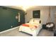 Stylish bedroom showcasing a green accent wall with whimsical decor and a hanging chair at 15203 Shoreway Ct, Carmel, IN 46032