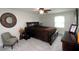 Cozy bedroom with neutral walls, ceiling fan, and a round decorative mirror at 15203 Shoreway Ct, Carmel, IN 46032
