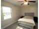 Bedroom with ceiling fan, window, light walls, and neutral colored bedding at 15203 Shoreway Ct, Carmel, IN 46032