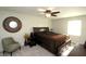 Bedroom featuring a ceiling fan, neutral walls, and round decorative mirror at 15203 Shoreway Ct, Carmel, IN 46032