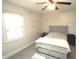 Bright bedroom with a gray upholstered headboard, neutral bedding, and sunlight streaming through the window at 15203 Shoreway Ct, Carmel, IN 46032