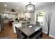 This dining area features an open floor plan with modern lighting and wood flooring throughout at 15203 Shoreway Ct, Carmel, IN 46032