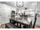 Bright dining room with white cabinets, a modern chandelier, and dark wood table at 15203 Shoreway Ct, Carmel, IN 46032