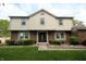 Classic two-story home featuring a combination brick and siding exterior with well-kept lawn and shrubs at 15203 Shoreway Ct, Carmel, IN 46032
