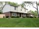 Well-maintained two-story house with brick and siding exterior with a lush green lawn and manicured shrubs at 15203 Shoreway Ct, Carmel, IN 46032